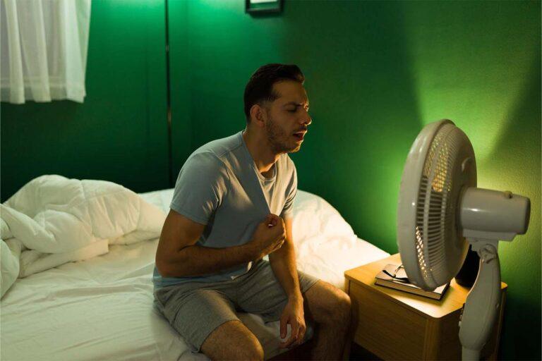 person feeling sudden body heat at night in bed